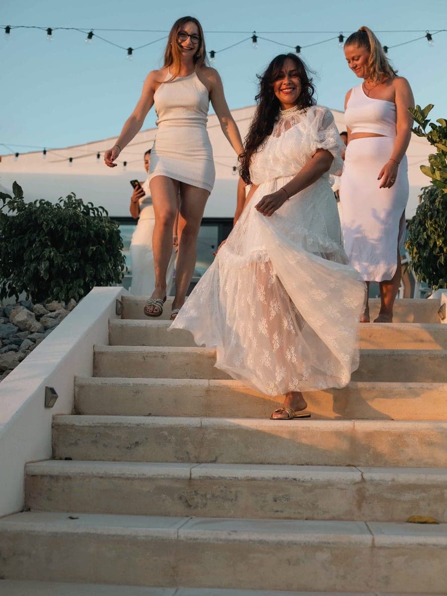 Camila Mello descending stone steps at golden hour