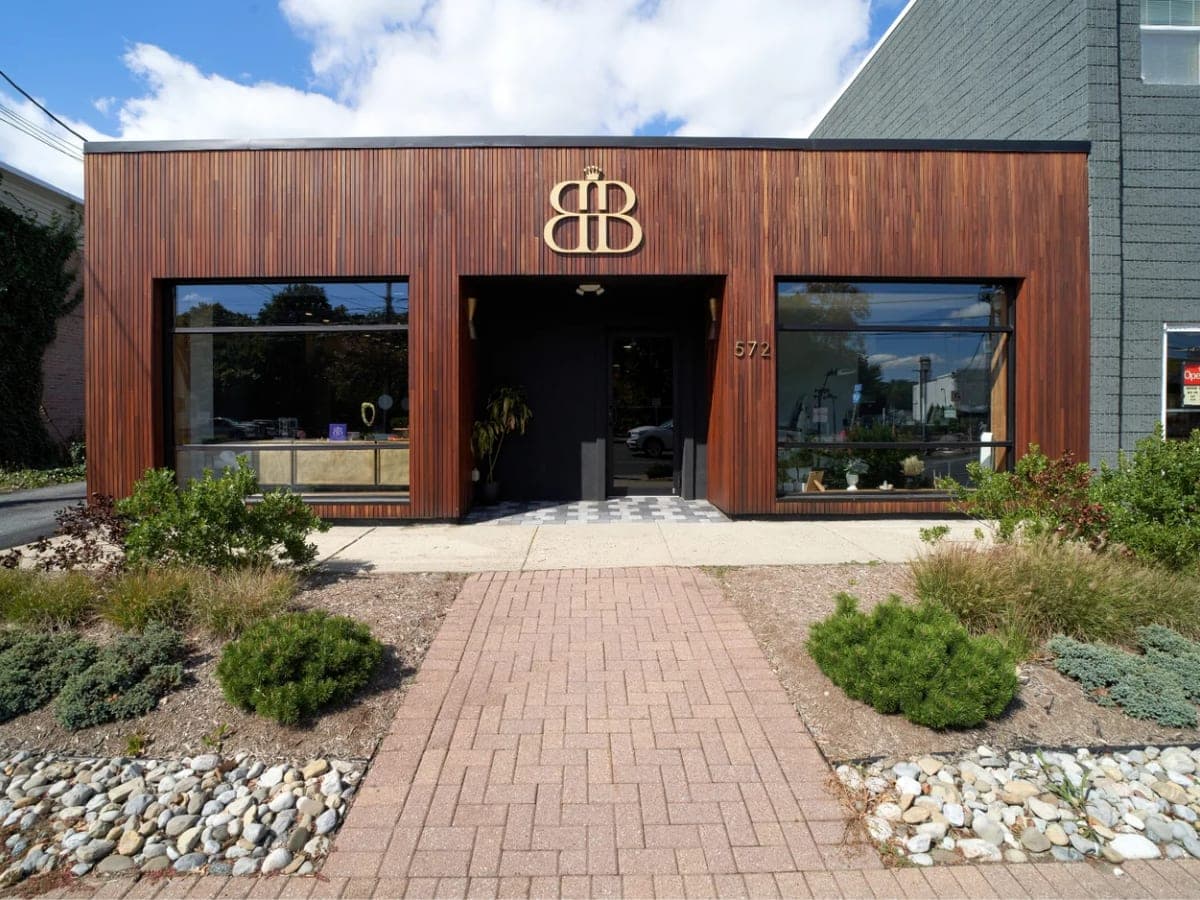 The Beauty Bar storefront: a timber-clad building with the BB monogram above the door